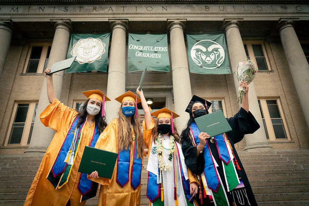 Graduates celebrating their graduation on the steps of the Administration Building on CSU's campus